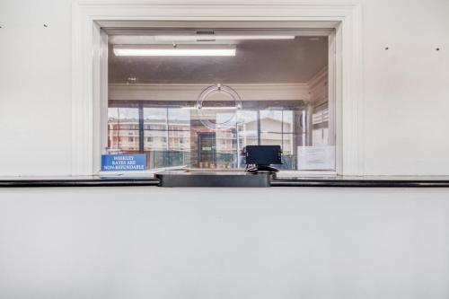 a window in a white room with a sink at OYO Hotel Baton Rouge East I-12 Louisiana in Baton Rouge