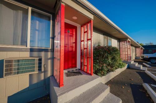 a red door on the side of a building at OYO Hotel Portland OR near Airport in Gresham