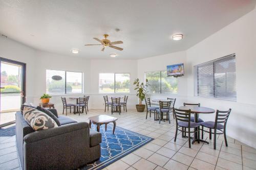 a living room with a couch and tables and chairs at OYO Woodland Hotel and Suites in Woodland
