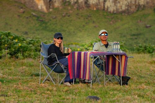 a man and a woman sitting at a table at Hotel Hare Uta in Hanga Roa