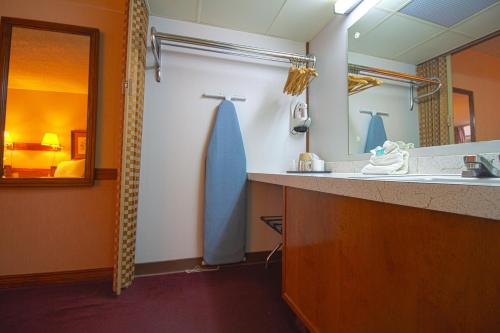 a bathroom with a sink and a mirror at HomeTown Inn By OYO - Liberal, KS in Liberal