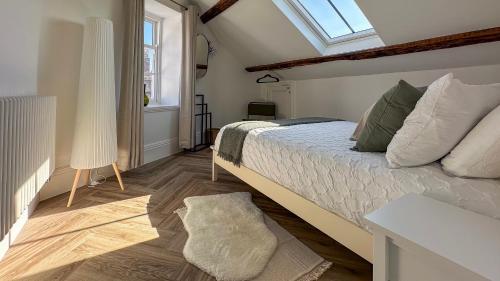 a bedroom with a large bed and a window at Family Holiday Home by the Great Orme Tramway and Beach in Llandudno