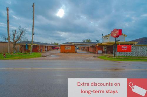 an empty street in a small town with a stop sign at Texana Inn Edna By OYO in Edna