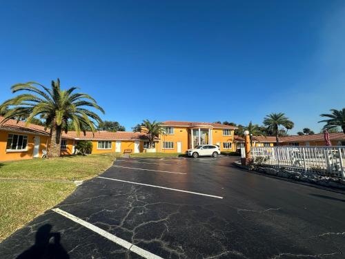 a parking lot with a car parked in front of a building at Super Inn By Oyo Daytona Beach Near Airport in Daytona Beach