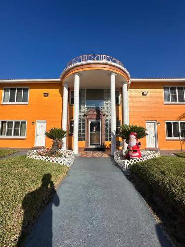 an orange building with a walkway in front of it at Super Inn By Oyo Daytona Beach Near Airport in Daytona Beach