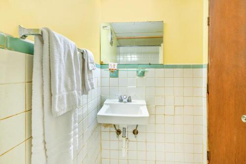 a bathroom with a sink and a mirror at OYO Hotel Downtown Peoria I-74 in Peoria