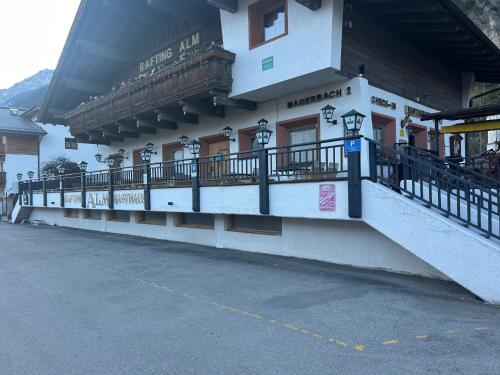 a building with a balcony on the side of it at Inn-side ADVENTURE CABINS in Haiming