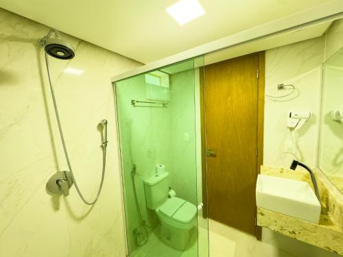 a bathroom with a shower and a toilet and a sink at Star Palace Hotel Jeri in Jericoacoara