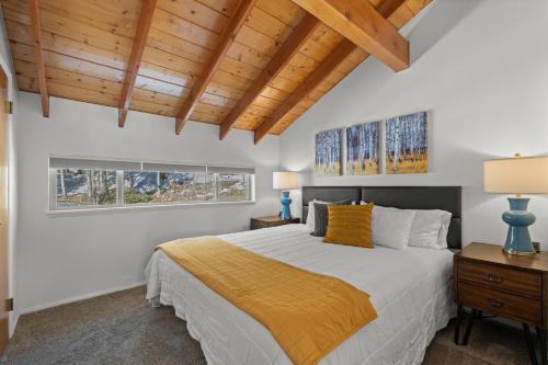 a bedroom with a bed and a wooden ceiling at 10A Condo Chalet Village Brian Head UT in Brian Head