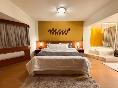 Ένα ή περισσότερα κρεβάτια σε δωμάτιο στο Hotel Caiuá