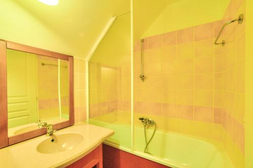 une salle de bain avec une baignoire, un lavabo et une douche dans l'établissement La résidence du Lac - maeva Home - Appartement 2 pièces 5 personnes - Sélection MAE-7651, à Monflanquin
