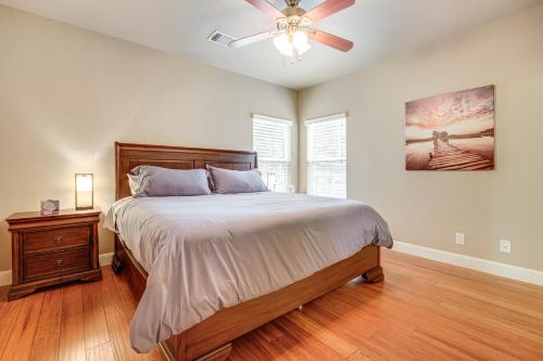 a bedroom with a bed and a ceiling fan at Less Than 1 Mi to Comal Park Peaceful Duplex with Yard! in Canyon Lake