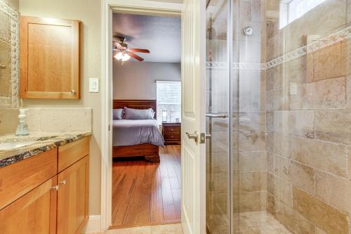 a bathroom with a shower and a bed in a room at Less Than 1 Mi to Comal Park Peaceful Duplex with Yard! in Canyon Lake