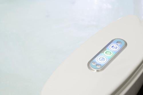 a remote control sitting on top of a cell phone at Eos - Elegants Apartments & Suites in Siracusa