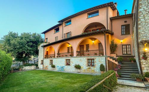 a large building with a lawn in front of it at Hotel La Fattoria in Spoleto