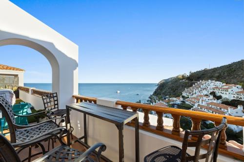 a balcony with chairs and a view of the ocean at H1786 - Hamilton Cove Villa 17-86 in Avalon