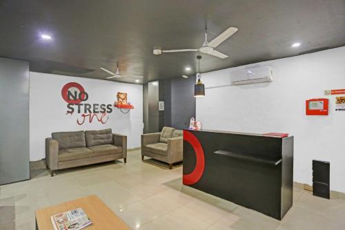 a lobby with couches and a wall with a no stress sign at Townhouse Nangal Raya Pankha Road in New Delhi