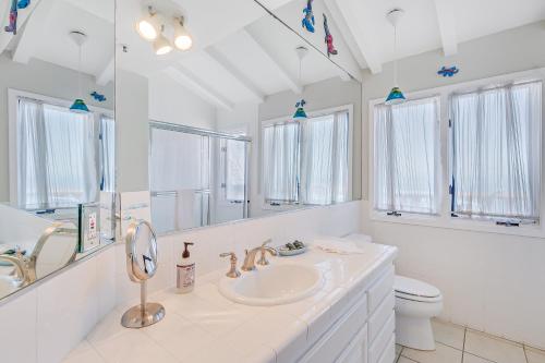 a white bathroom with a sink and a toilet at H180 - Hamilton Cove Villa 1-80 in Avalon