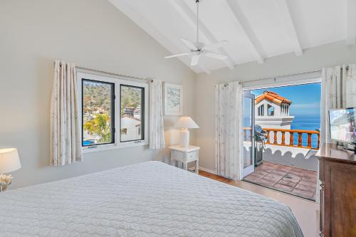 a bedroom with a bed and a view of the ocean at H180 - Hamilton Cove Villa 1-80 in Avalon