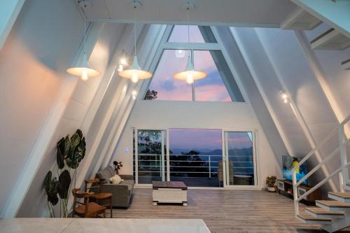 a large living room with a large window at Casa Clara Monteverde in Puntarenas