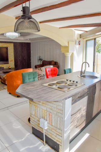 a kitchen with a counter with a sink in a room at Modern Delux 2 Bedroom Townhouse in Bloemfontein