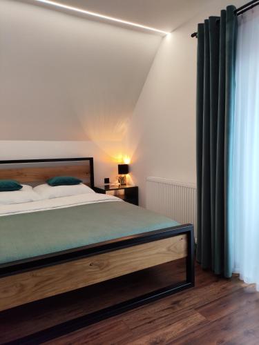 a bedroom with a large bed and a window at Noclegi SKORUSINKA in Witów