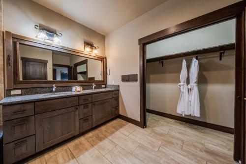 a bathroom with a sink and a large mirror at Treehouse at the Wilderness Club in Eureka