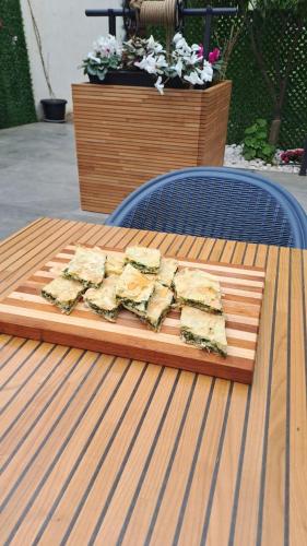 a pile of food on a cutting board on a table at Mon Ami Boutique Hotel in Shkodër
