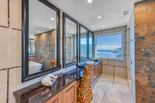 a bathroom with two sinks and a large window at H208 - The Honeymoon Penthouse Suite Palazzo De Mare in Avalon