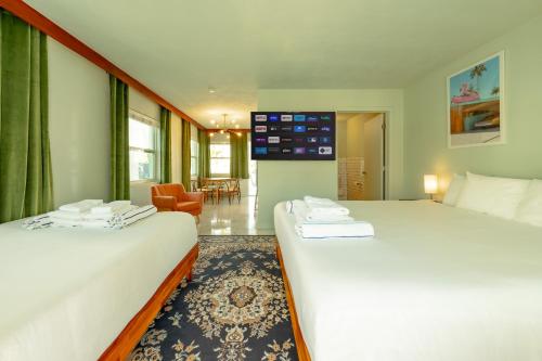 a hotel room with two beds and a living room at Tropical Breeze in Clearwater Beach