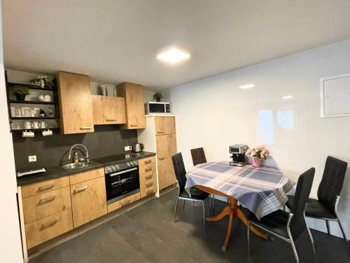 a kitchen with a table and chairs in a room at Apartment in Hügelsheim