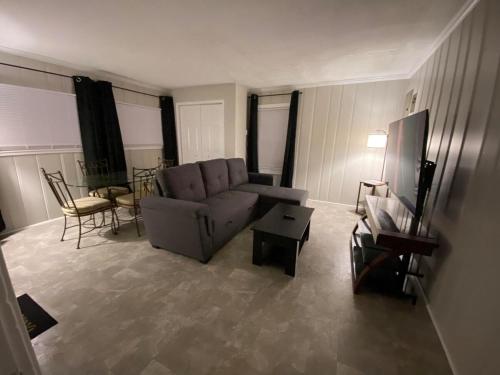 a living room with a couch and a table at Oasis within a short walk to uptown in High Point