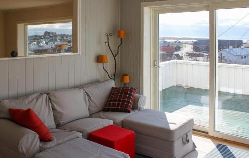 a living room with a couch and a large window at 5 Bedroom Nice Home In Borhaug in Borhaug