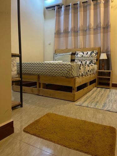 a bedroom with a wooden bed and a window at city zeze kinondoni in Dar es Salaam