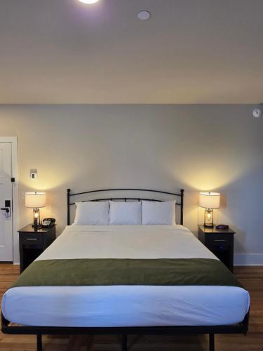 a bedroom with a large bed with two night stands at Historic Griffin Hotel in Griffin