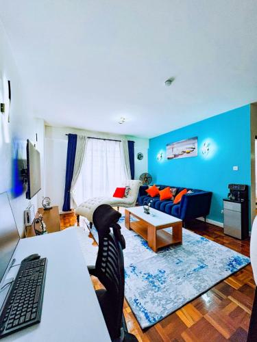 a living room with blue walls and a blue couch at Urban Vibes Getaways - Premium Westlands Nairobi Apartment with Luxury Amenities in Nairobi