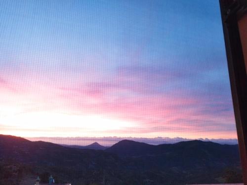 a view of the sunset from the top of a mountain at Appartamenti La Collina in Jerzu