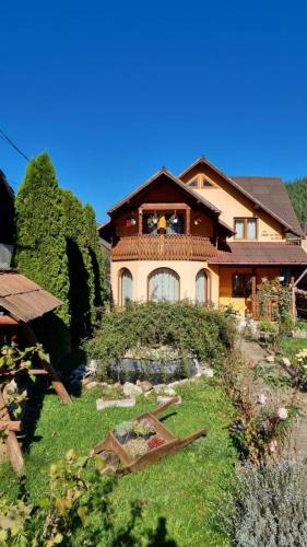 a house with a garden in front of it at Casa Georgeta in Câmpulung Moldovenesc