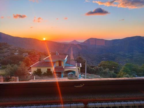 a view of a train station with the sunset at Appartamenti La Collina in Jerzu