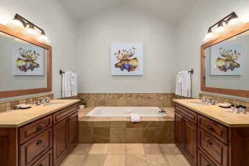 a bathroom with two sinks and a bath tub at The Porches in Steamboat Springs
