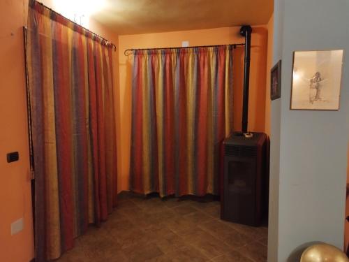 a room with curtains and a television in a room at Appartamenti La Collina in Jerzu