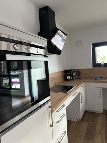 a kitchen with a stainless steel oven and a sink at Bei Haags in Gommersheim