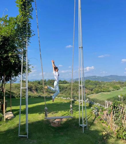 a person jumping in the air on a swing at 张家界东篱山居民宿- Free pick up service in Zhangjiajie