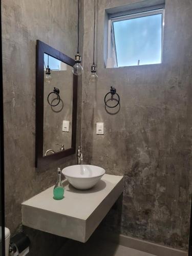 a bathroom with a sink and a mirror at Casa de Campo Pampulha in Belo Horizonte