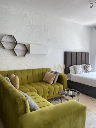 a living room with a couch and a bed at Cozy Corner in Sandton