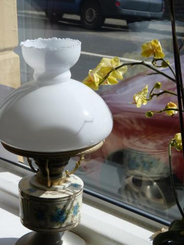 a lamp sitting in a window next to a vase at The Iverna in Eastbourne
