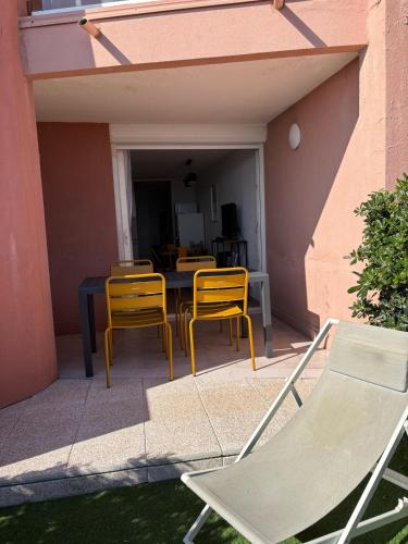 - une terrasse avec 2 chaises, une table et des chaises dans l'établissement SèteÔSoleil, à Sète