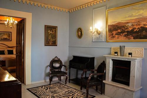 a living room with a piano and a fireplace at Rincón Aranzazú Breakfast & Terrace in San Luis Potosí