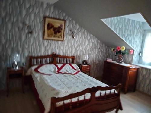 a bedroom with a bed with a red and white blanket at Demeure des Lions in Bouzeron