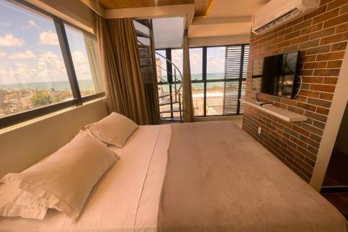 Cama ou camas em um quarto em Reserva Madero Loft Natal Hotel